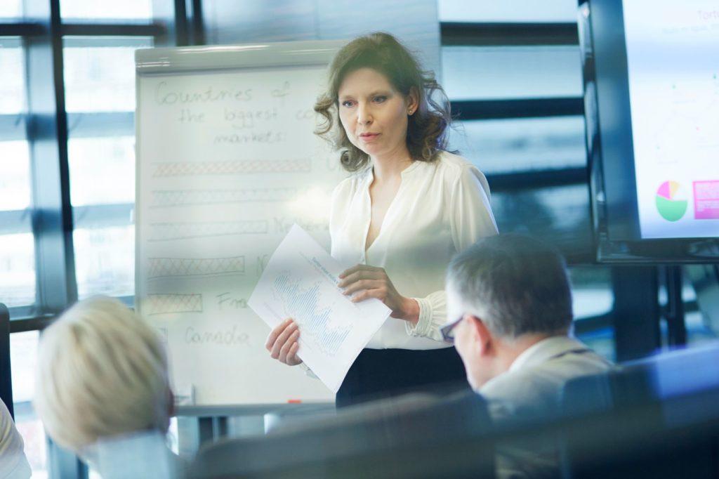 Female presenting in the boardroom.