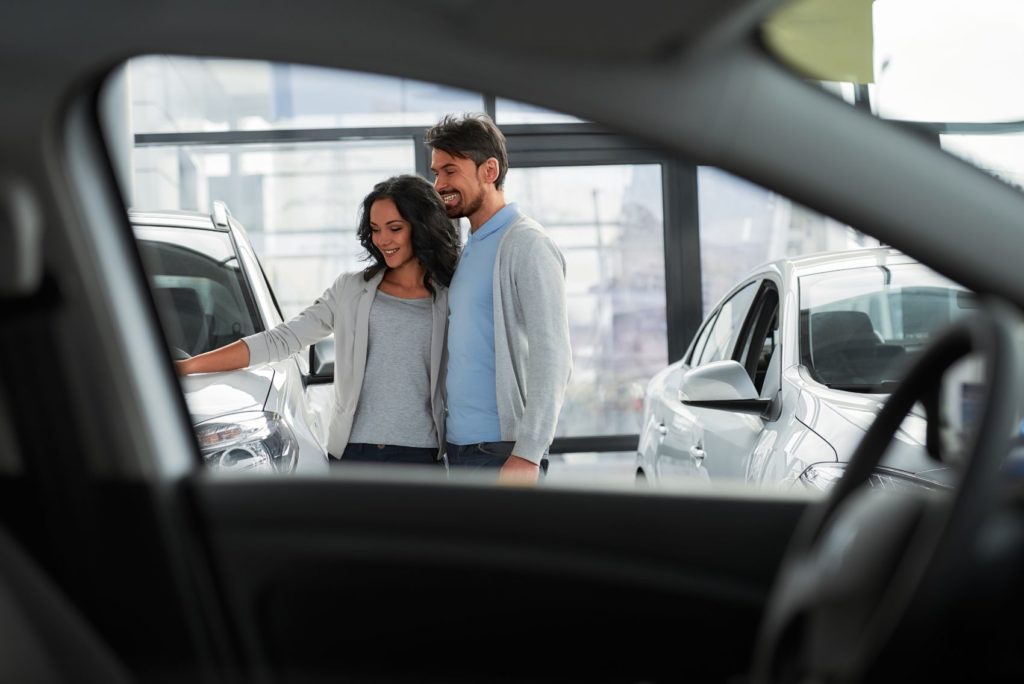 Customers on the showfloor of a car dealership.