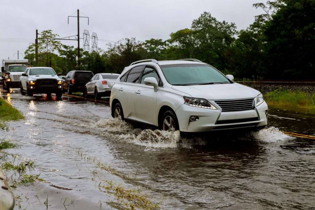 Cars driving on a flooded road. 