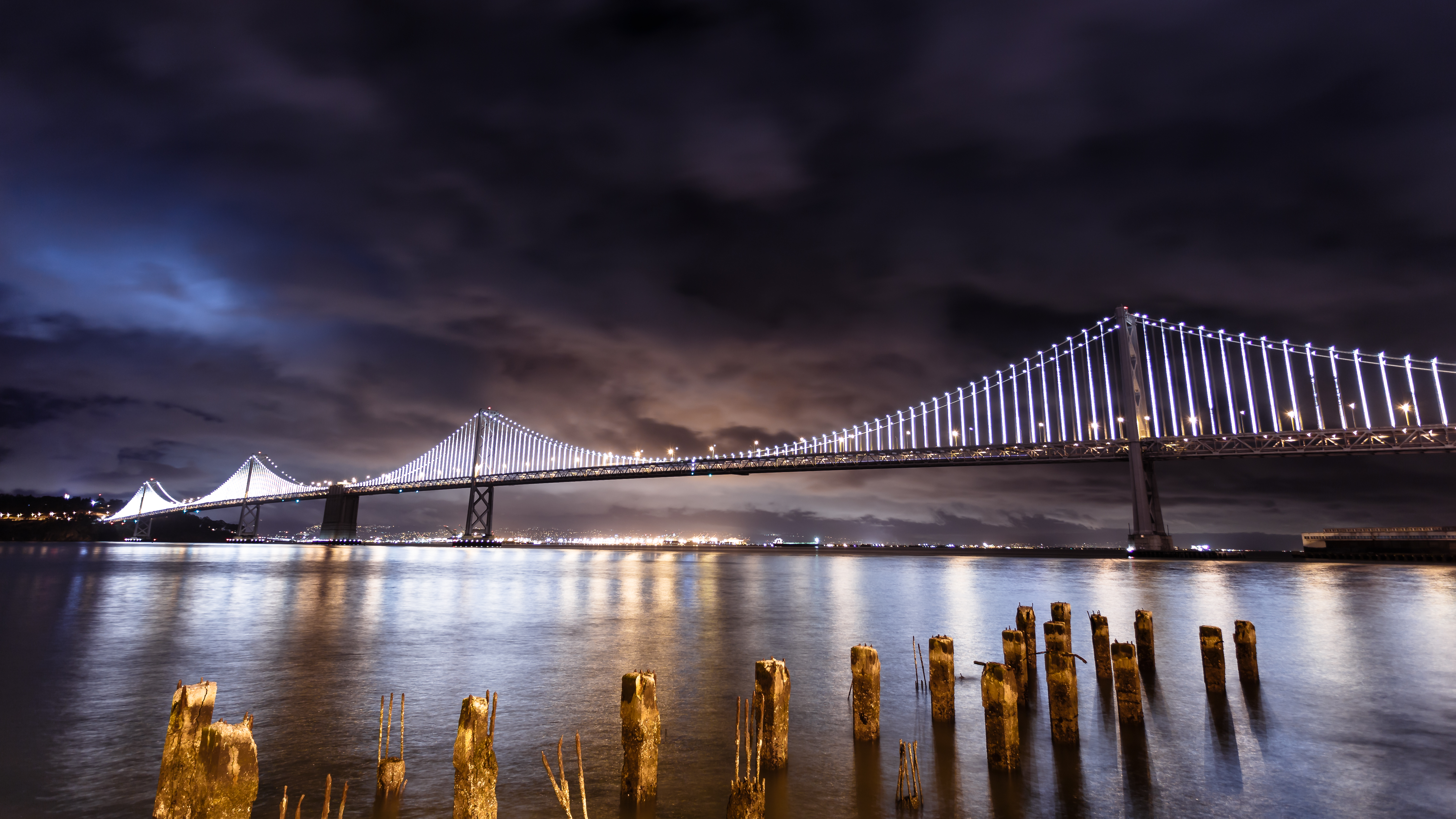 San Francisco-Oakland Bay Bridge illuminated at night.